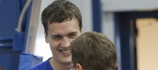 Former Kansas University center Sasha Kaun smiles as he greets coach Bill Self Tuesday at Selfs camp. Kaun is visiting Lawrence from his native Russia for the week.