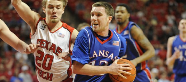 KU's Brady Morningstar drives the lane against Texas Tech's Alan Voskuil on Wednesday, March 4, 2009 at United Spirit Arena in Lubbock, Texas.