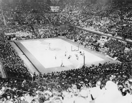 A packed house watches a game in the early days of Allen Fieldhouse.  The Fieldhouse was an improvement on the tight spaces and concrete floor of Hoch Auditorium.