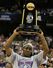 Sherron Collins hoists the title trophy after one of the best championships of all time. (Getty Images)